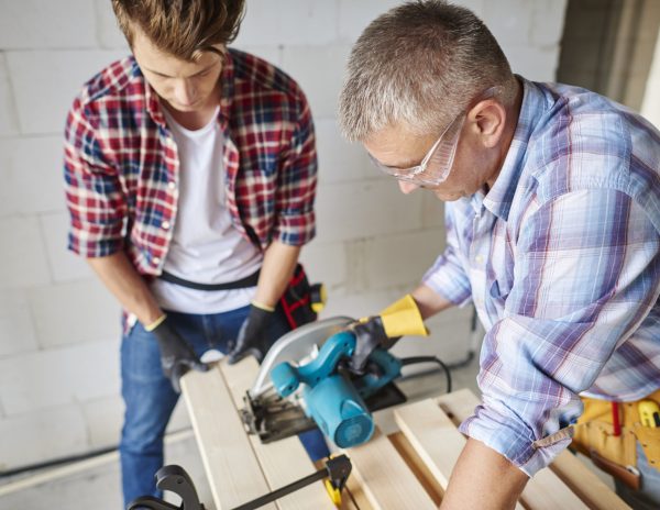 Carpenter cuts wooden planks with jigsaw