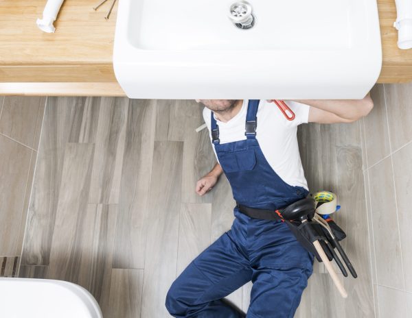 sanitary-technician-lying-sink